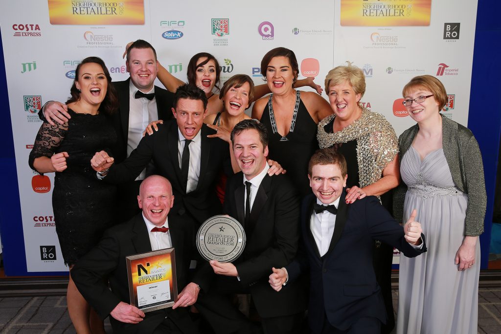Jonathon Crawford (centre) is pictured with DJ Stephen Clements (left of centre) and the Crawfords of Maghera staff after winner the first Community Store of the Year award. 